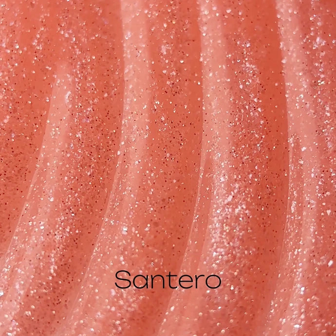 Close-up of pink glitter UV nail gel texture, shimmering with fine sparkles, labeled Santero