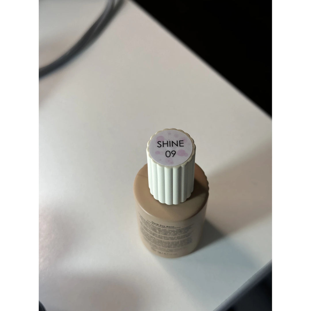 SHINE 09 UV gel nail polish bottle on a white surface, manicure product close-up