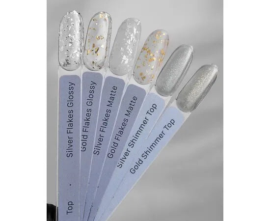 Nail polish swatches with silver flakes, gold flakes, and shimmer top coats for manicures.