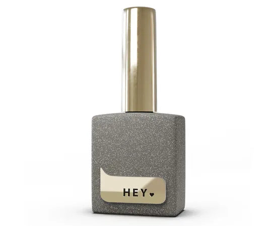 Silver glitter gel nail polish bottle with gold cap, labeled HEY, for manicure