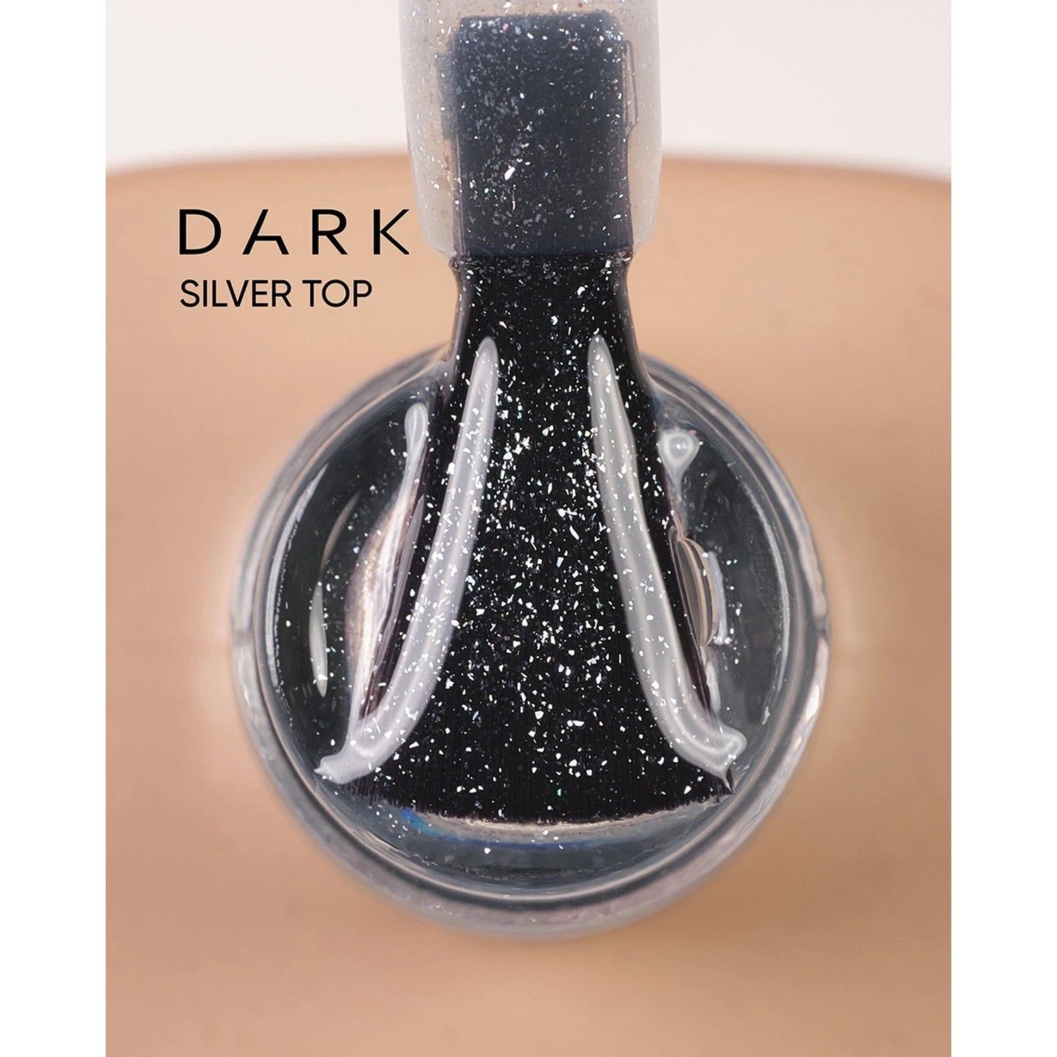 Brush with dark silver glitter top coat nail polish for manicure application