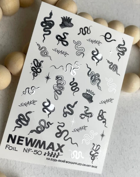 Sheet of metallic nail art stickers with snake and crown designs, manicure accessories