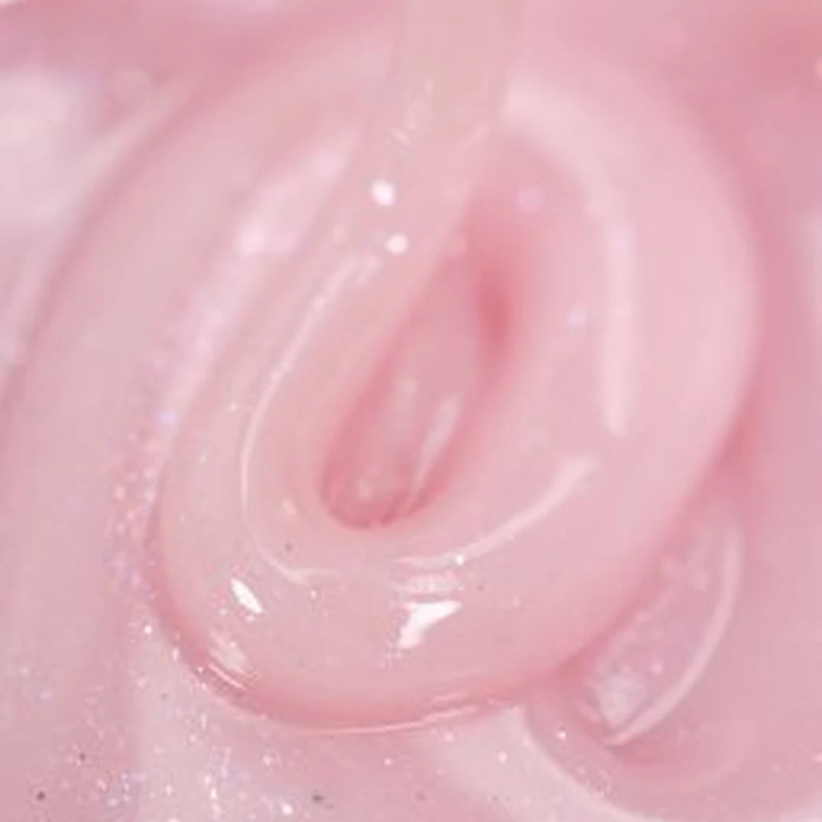 Close-up of shimmering pink UV gel nail polish with glossy texture
