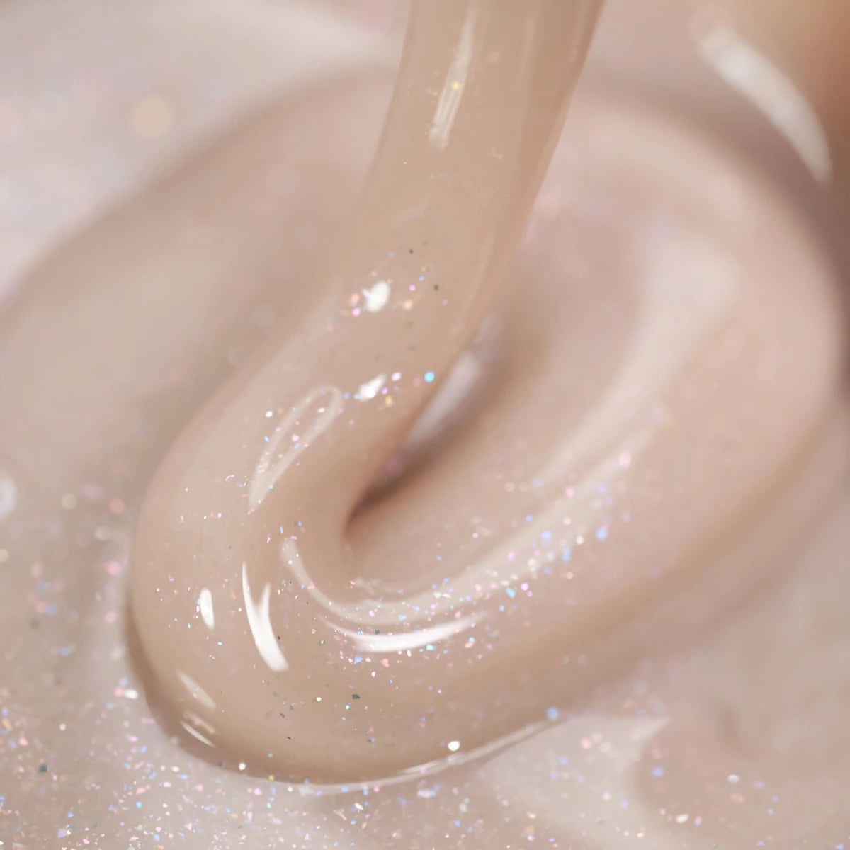 Close-up of shimmery nude UV gel for nails, ideal for manicures and nail art.
