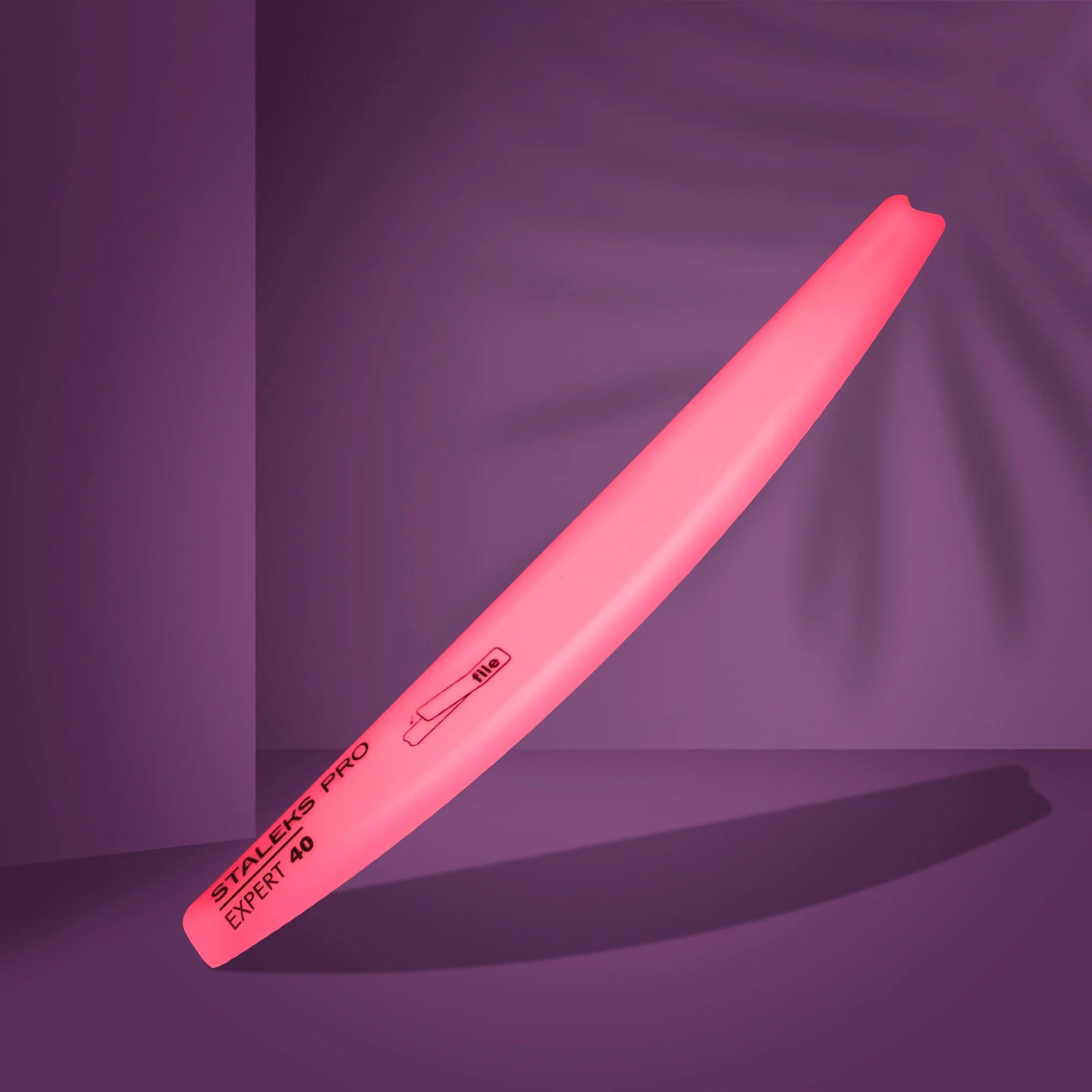 Pink nail file Staleks Pro Expert 40 for manicure on purple background