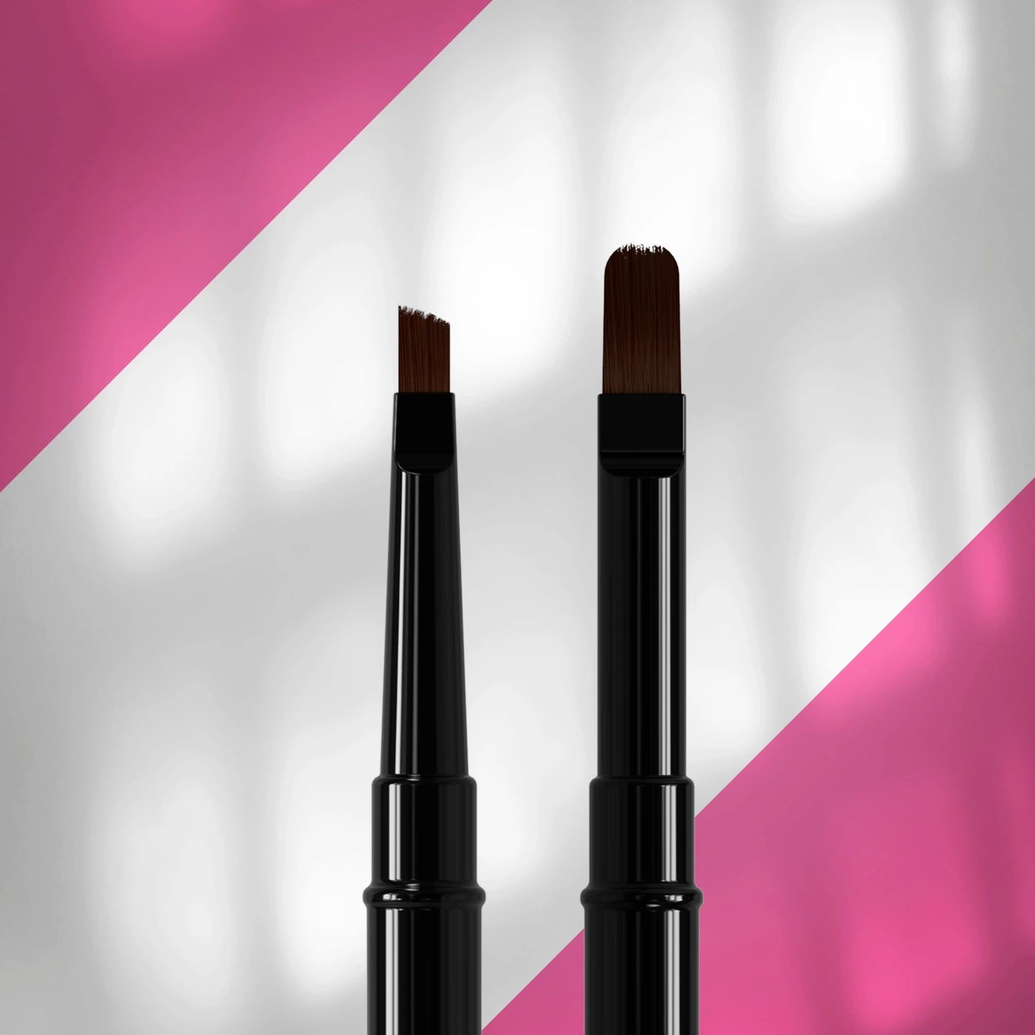 Two professional nail art brushes with black handles on a pink and white background