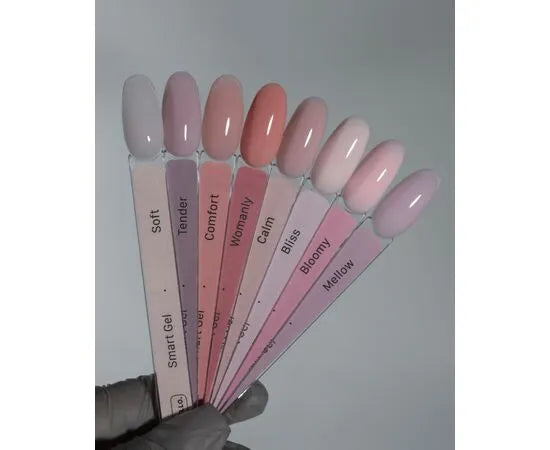 Assorted nude and pink gel nail polish color swatches on sample sticks for manicure