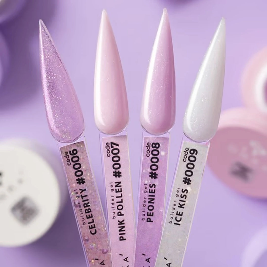 Four stiletto-shaped nail tips coated in glossy purple-toned nail polish shades, shown upright with product labels. The shades are labeled Celebrity, Pink Polen, Peonies, and Ice Kiss, in pastel pink, lavender glitter, light pink, and icy white.