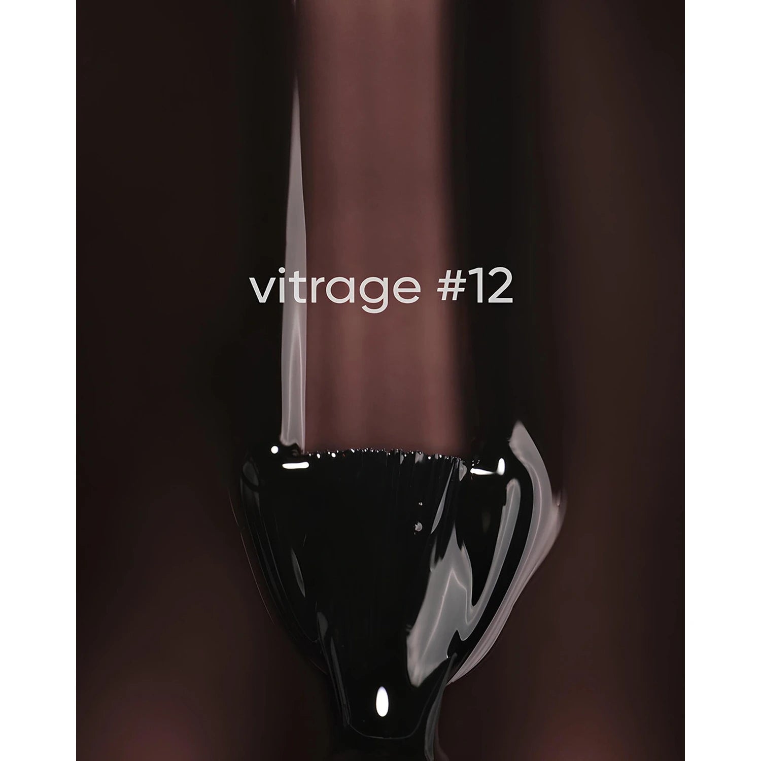 Close-up of a dark gel nail polish brush with text 'vitrage #12' on a brown background.